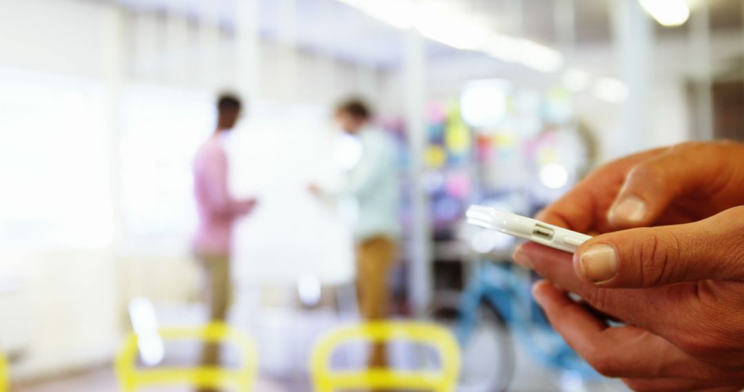 Businessman Texting in Modern Office Workspace