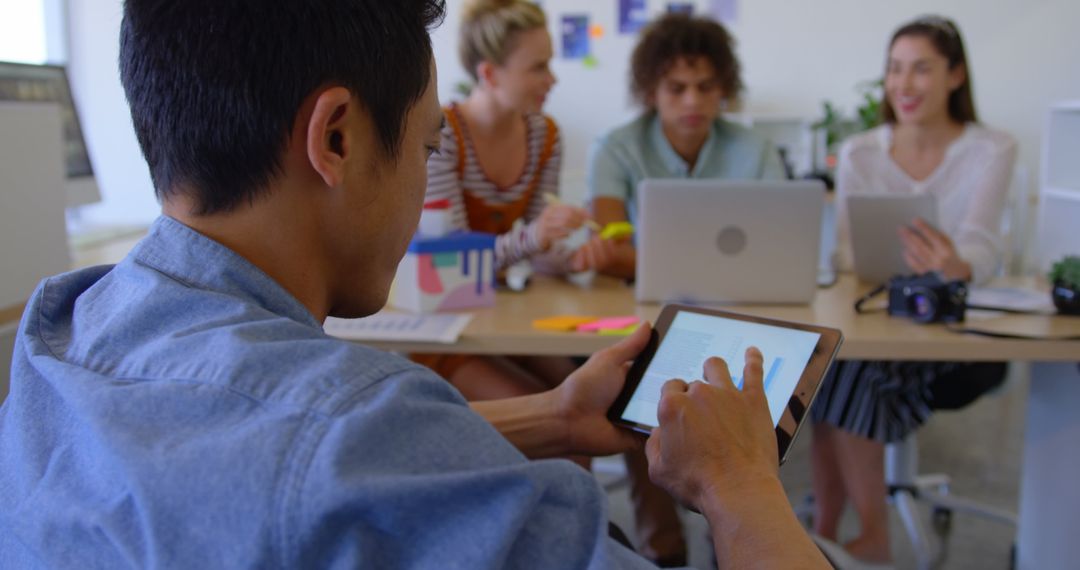 Young Professionals Collaborating in Modern Office with Technology