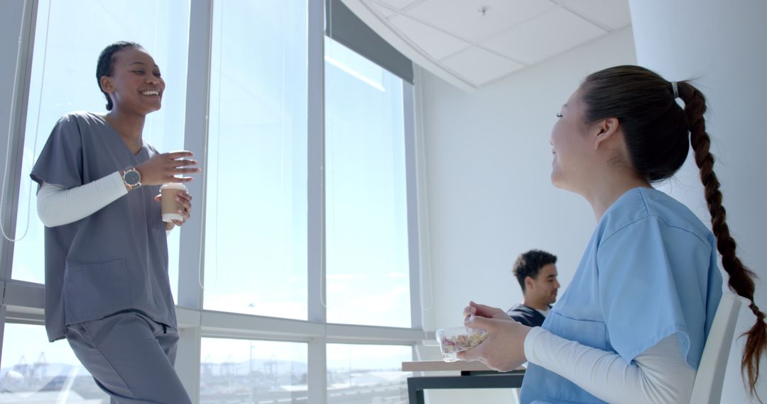 Diverse Healthcare Workers Sharing a Relaxing Break in Bright Hospital