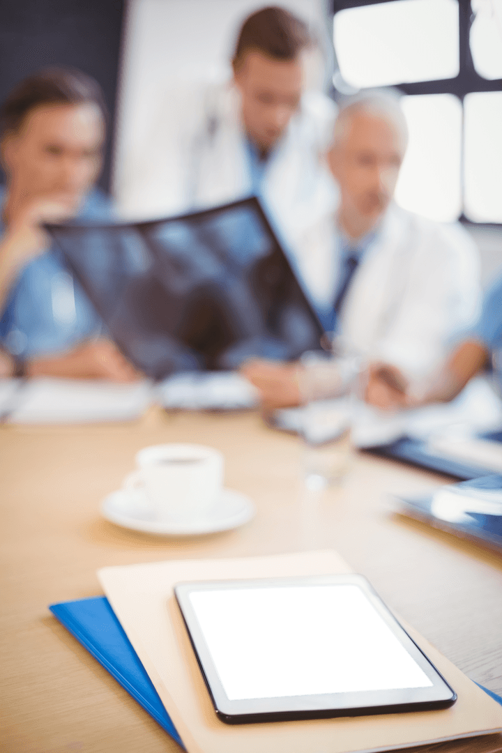 Transparent Doctors Discussing Diagnosis with Tablet in Foreground