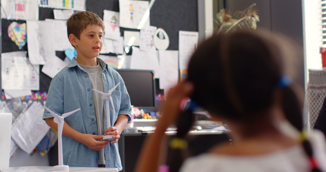 Elementary Student Presenting Windmill Model in Classroom