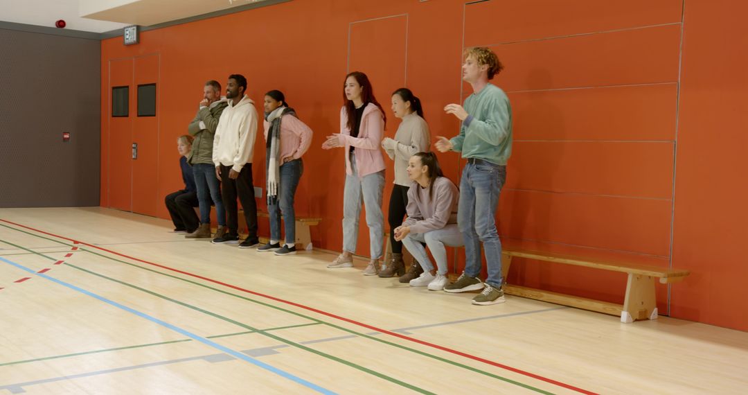 Diverse Friends Cheering in Sports Hall Vibrant Team Spirit Celebration