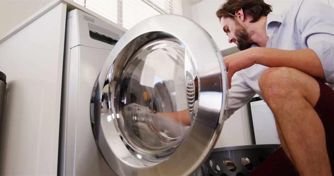 Man Using Washing Machine in Modern Laundry Room - Free Images, Stock Photos and Pictures on Pikwizard.com