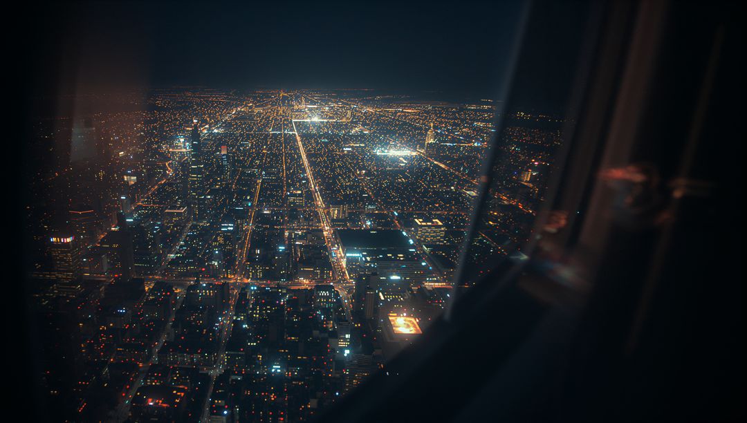 Aerial Night View of Urban Streets Through Airplane Window