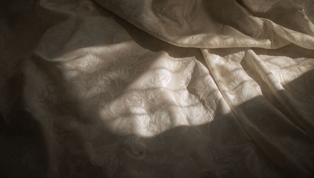 Sunlit Cream Damask Bedspread With Soft Folds, Floral Jacquard Texture and Shadow Play