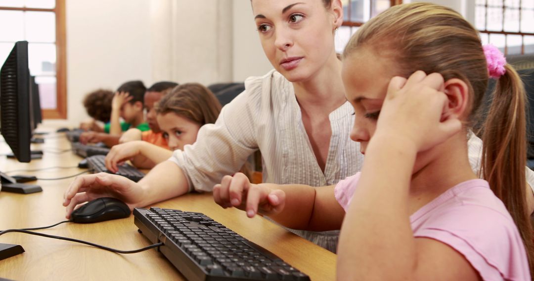 Teacher Assisting Elementary Students in Computer Class - Free Images, Stock Photos and Pictures on Pikwizard.com