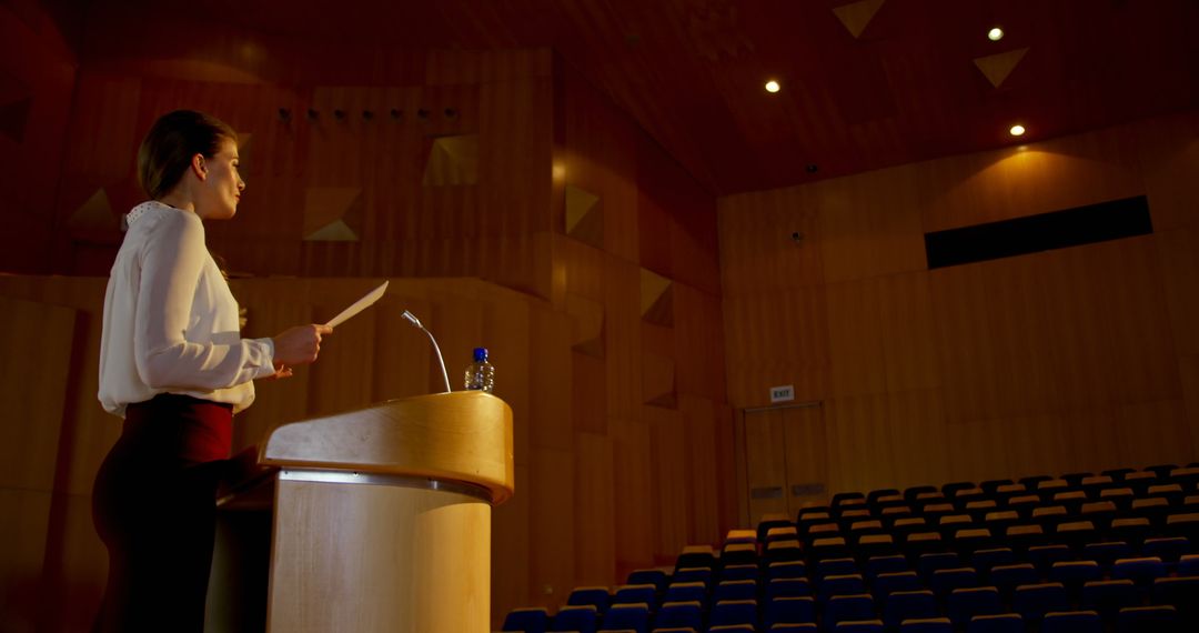 Confident Businesswoman Rehearsing Speech in Auditorium