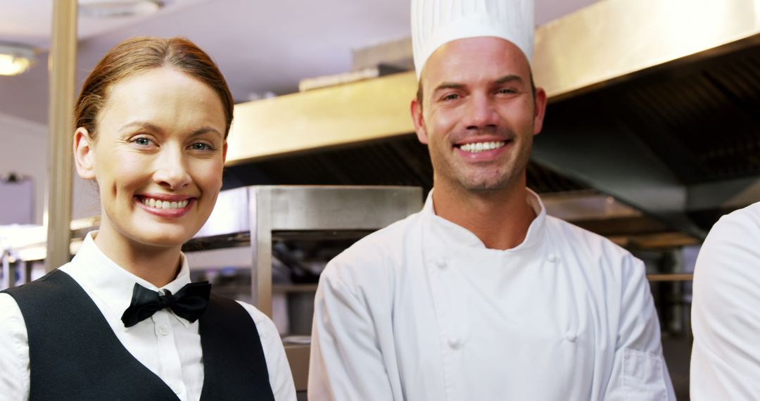 Smiling Chef and Waitress in Professional Kitchen - Free Images, Stock Photos and Pictures on Pikwizard.com