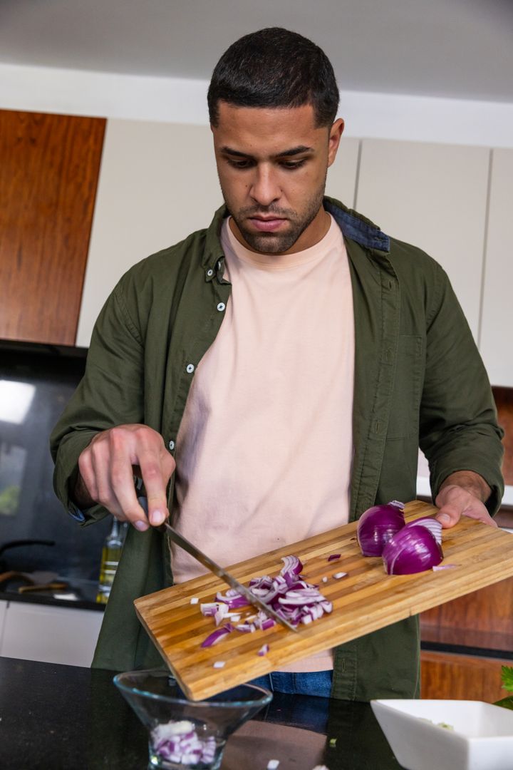 Man Preparing Ingredients for Cooking in a Modern Kitchen