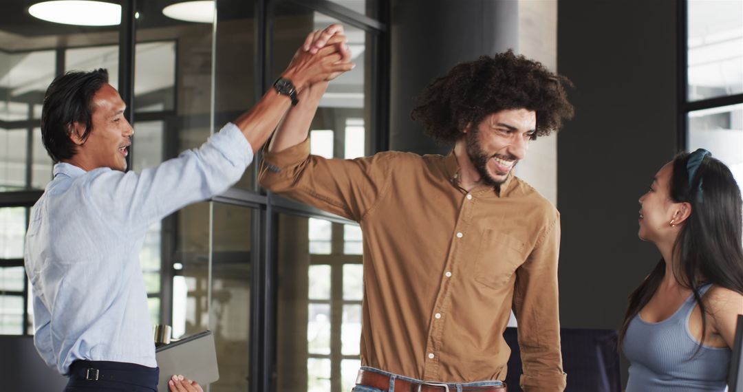 Happy Diverse Team Celebrating Success in Modern Office Environment