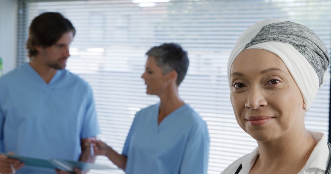 Confident Female Cancer Survivor with Medical Professionals in Background - Free Images, Stock Photos and Pictures on Pikwizard.com