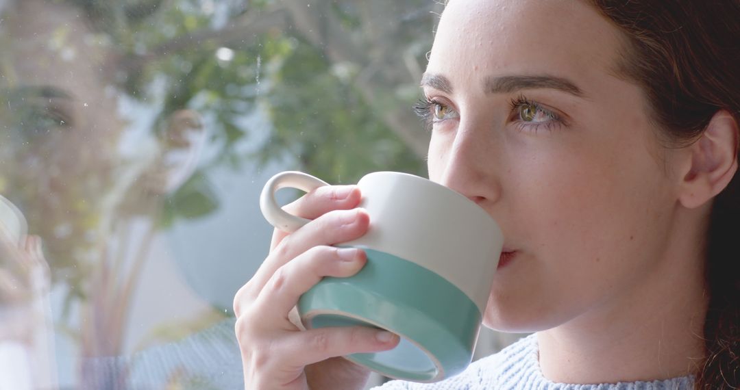 Young Woman Sipping Coffee By Window, Relaxing Morning - Free Images, Stock Photos and Pictures on Pikwizard.com