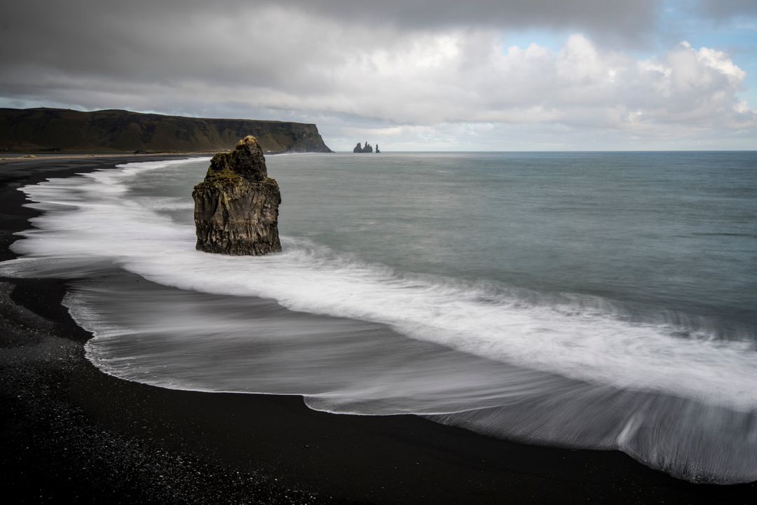 Dramatic Icelandic Black Sand Beach with Rock Formation and Waves - Free Images, Stock Photos and Pictures on Pikwizard.com