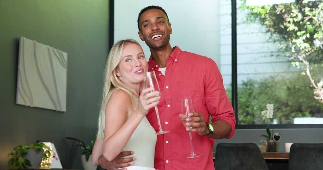 Interracial Couple Enjoying Celebration with Champagne at Home