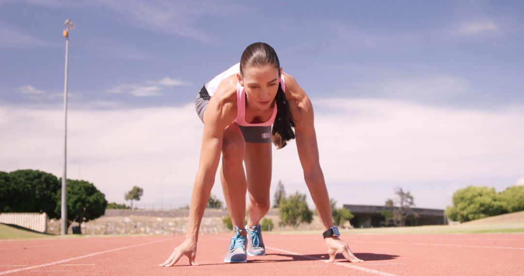 Female Athlete in Starting Position on Outdoor Running Track - Free Images, Stock Photos and Pictures on Pikwizard.com