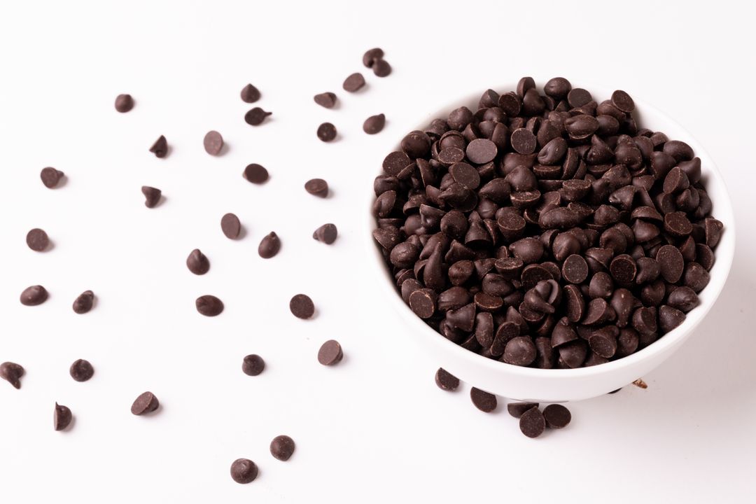 High Angle View of Chocolate Chips in Bowl on White Background - Free Images, Stock Photos and Pictures on Pikwizard.com