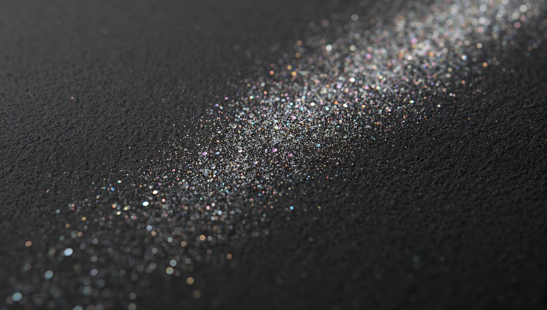 Diagonal Iridescent Glitter Trail on Textured Black Surface, Macro Sparkle Bokeh Background