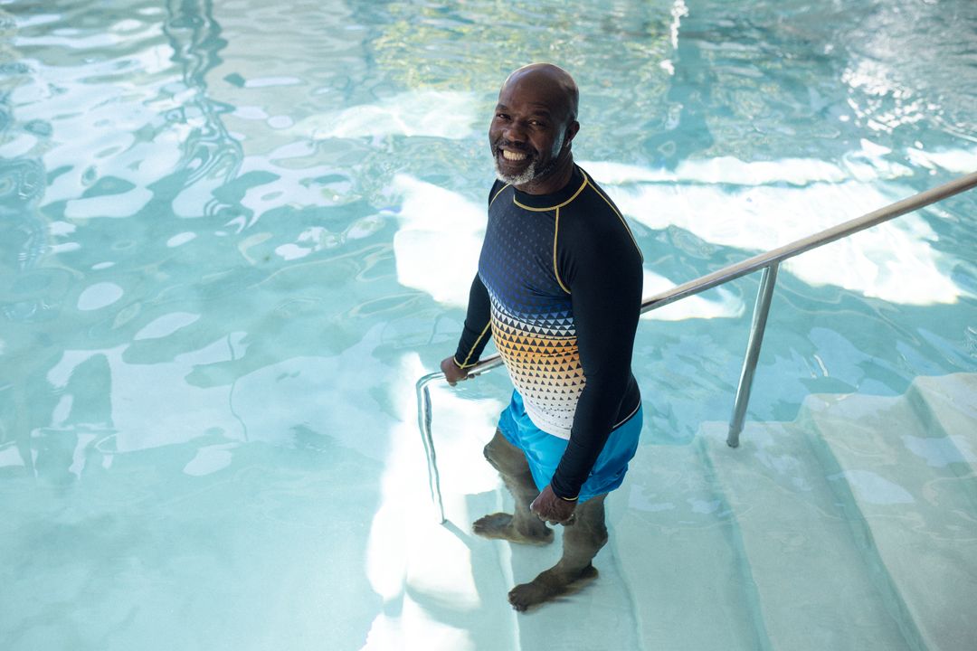 Image of happy african american man at swimming pool - Free Images, Stock Photos and Pictures on Pikwizard.com