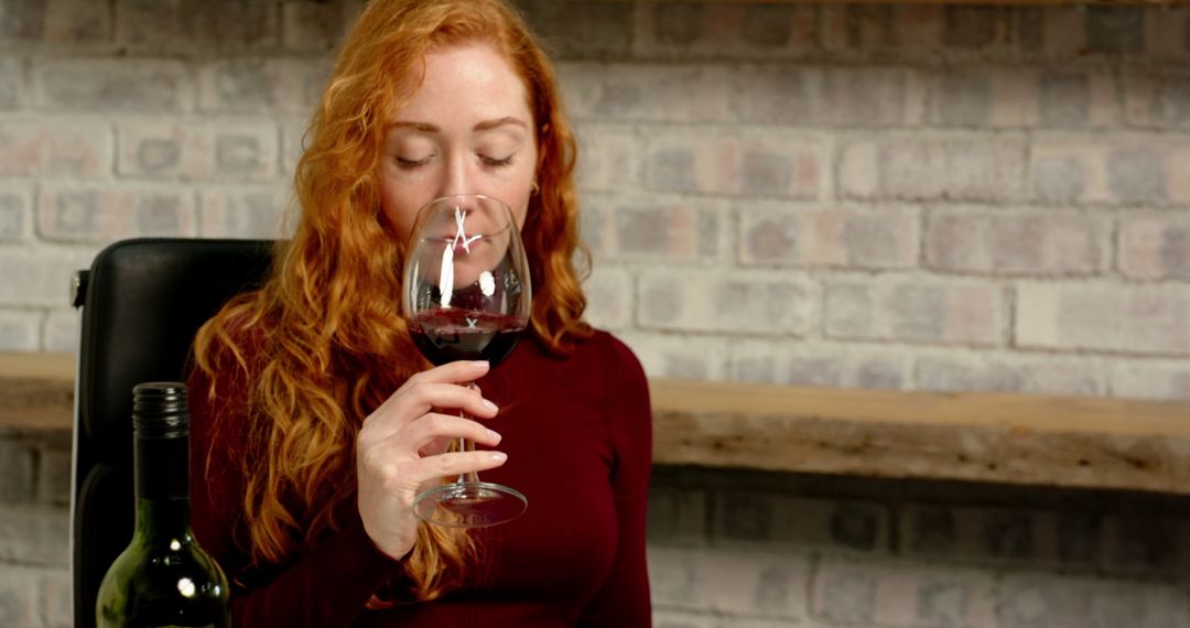 Red-haired Woman Enjoying Glass of Red Wine at Home