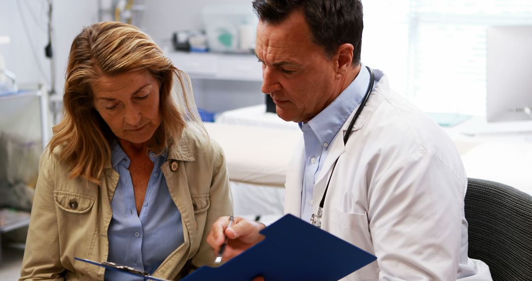 Doctor Discusses Patient's Medical Records During Consultation - Free Images, Stock Photos and Pictures on Pikwizard.com