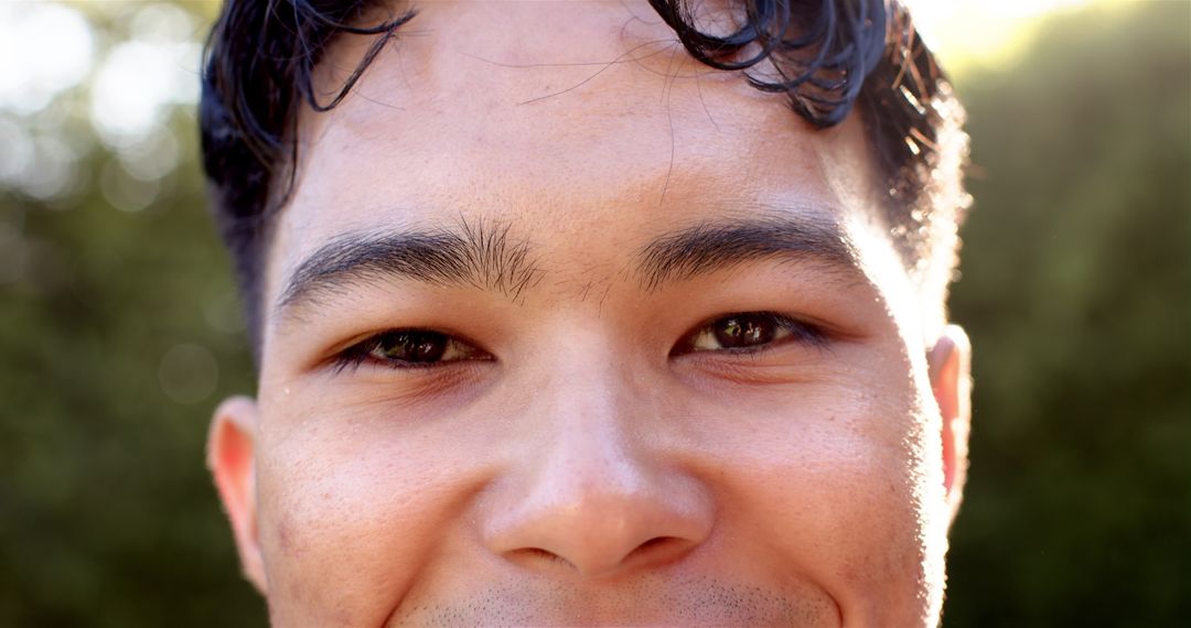 Close-Up of Young Man with Thoughtful Expression in Nature