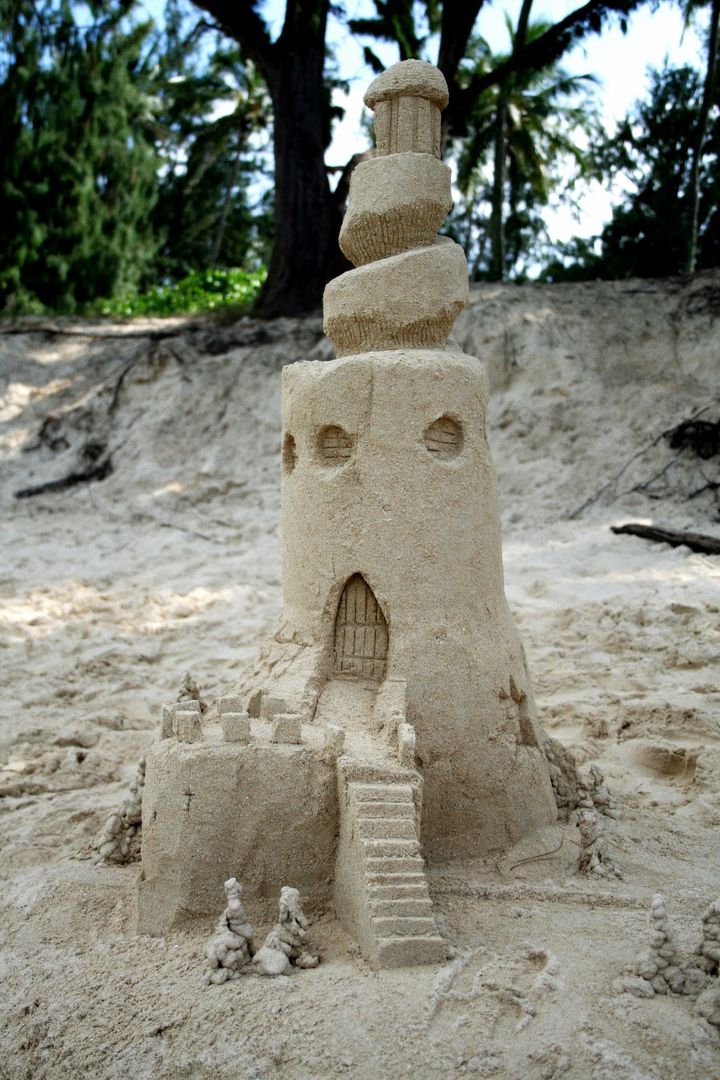 Intricate Sandcastle Designs with Tower on Beach