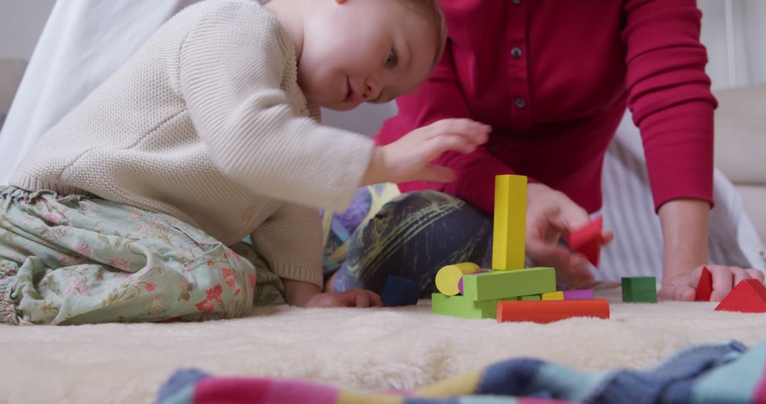 Toddler Playing with Colorful Building Blocks at Home - Free Images, Stock Photos and Pictures on Pikwizard.com