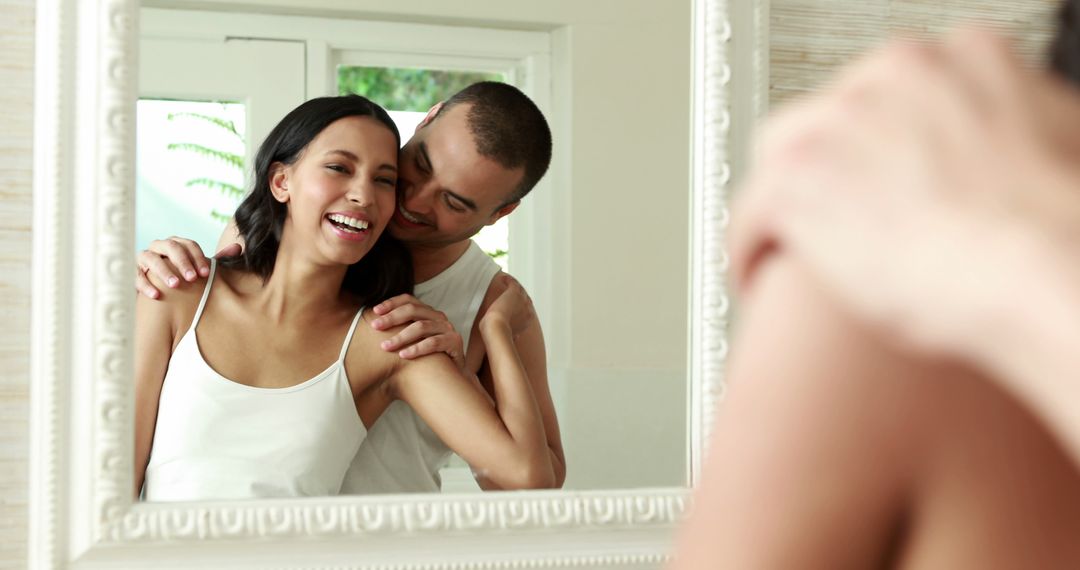 Happy Couple Embracing and Smiling in Mirror Reflection - Free Images, Stock Photos and Pictures on Pikwizard.com