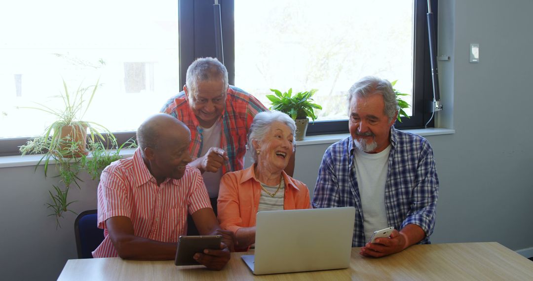 Senior Friends Laughing and Enjoying Technology Together - Free Images, Stock Photos and Pictures on Pikwizard.com