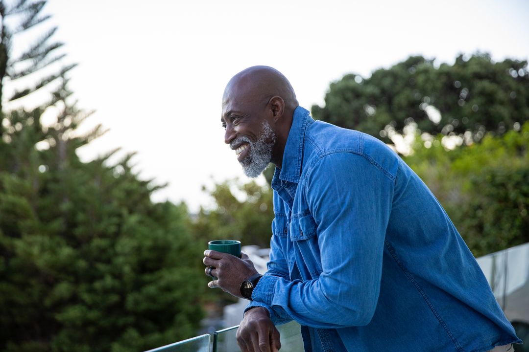 Senior Man in Denim Enjoying Solitude on Balcony