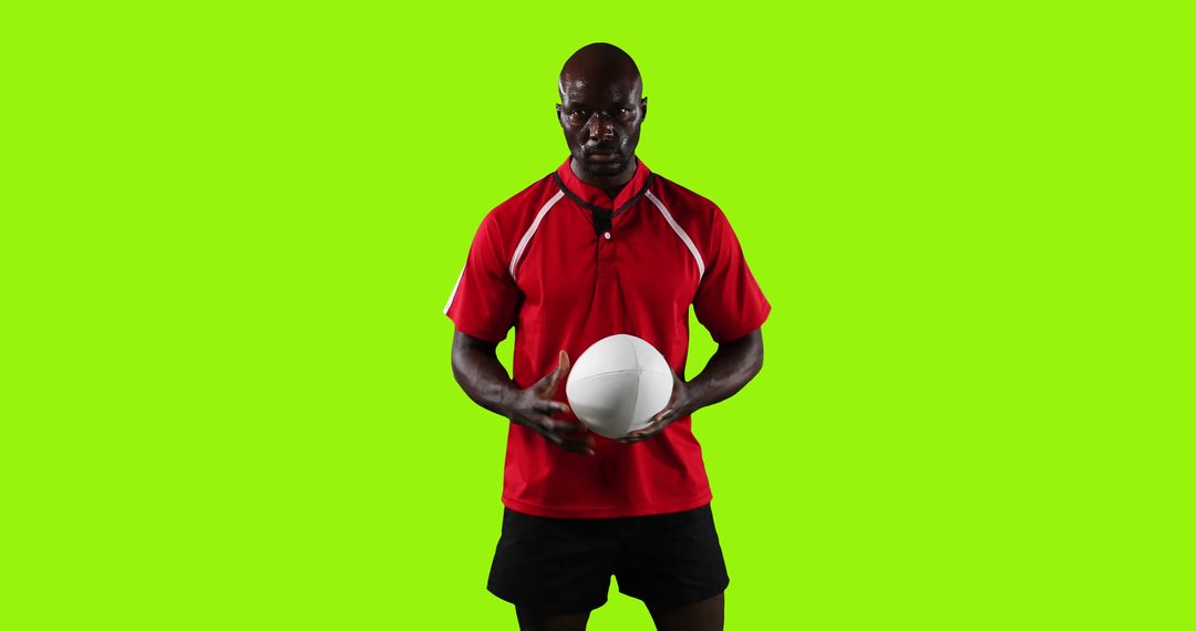 Athletic Man Holding Volleyball Wearing Red Shirt Against Green Background - Free Images, Stock Photos and Pictures on Pikwizard.com