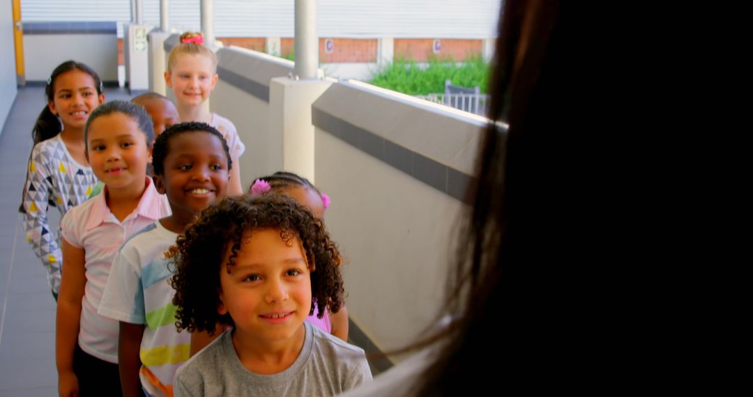Diverse Group of Schoolchildren Queuing with Teacher