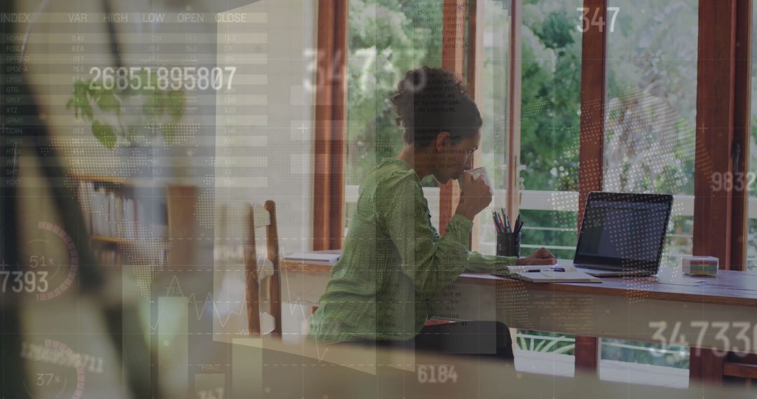 Side Working on Laptop Amid Digital Data Overlays