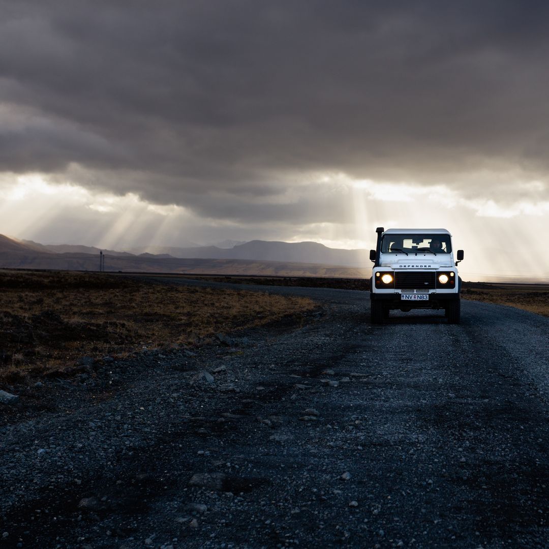 Off-road Vehicle on Remote Gravel Road under Dramatic Sky - Free Images, Stock Photos and Pictures on Pikwizard.com