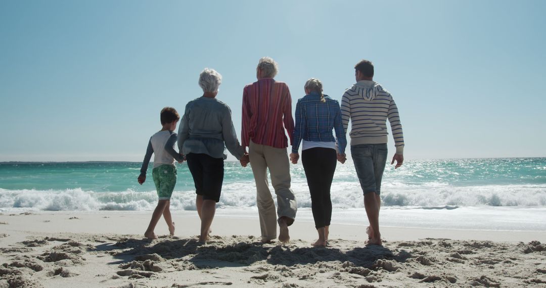 Multi-Generational Family Walking on Sunny Beach - Free Images, Stock Photos and Pictures on Pikwizard.com