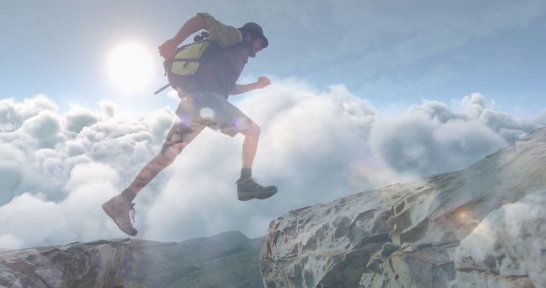 Adventurer Crossing Mountain Ledges Above Cloudscape