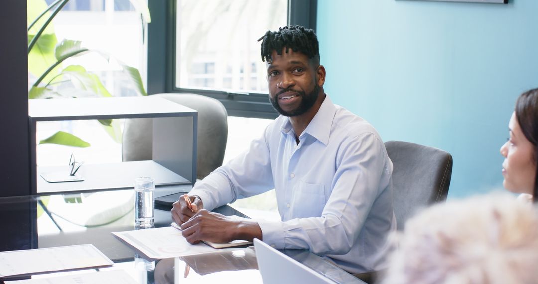Confident Businessman Engaging in Office Meeting Discussion