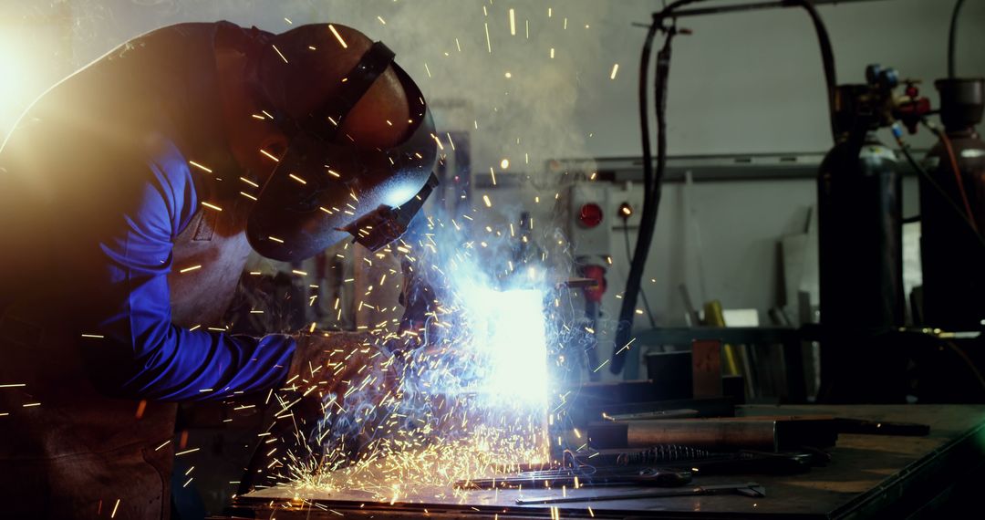 Welder Working with Safety Gear in Industrial Workshop - Free Images, Stock Photos and Pictures on Pikwizard.com