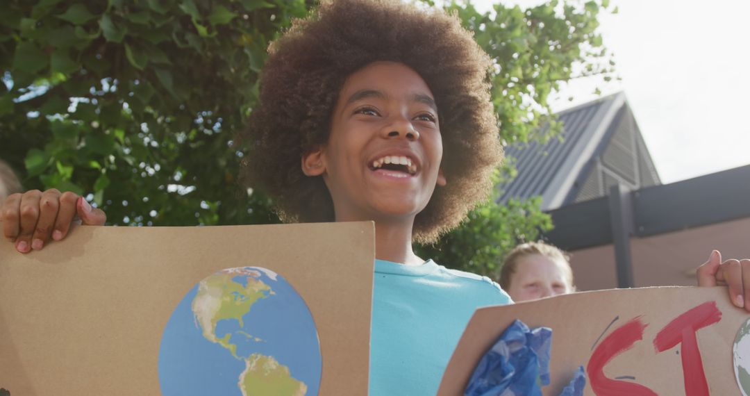 Smiling Child Holding Climate Advocacy Signs at Protest - Free Images, Stock Photos and Pictures on Pikwizard.com