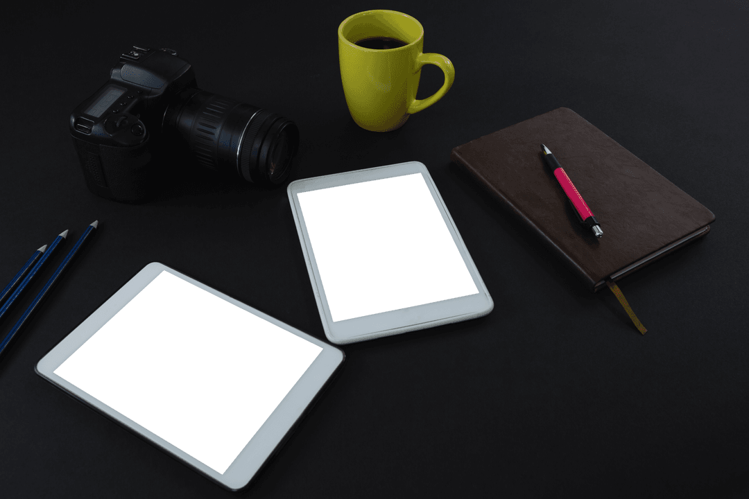 Transparent Devices on Dark Desk With Organizing Items