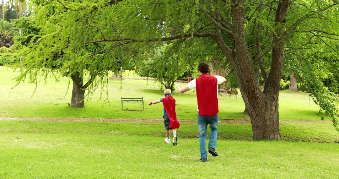 Father and Son Playing Superheroes in Park - Free Images, Stock Photos and Pictures on Pikwizard.com