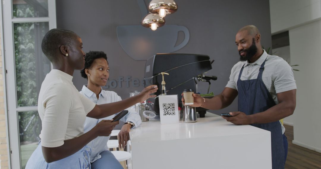 Barista Serving Coffee to Customers Using Smartphones for Payment - Free Images, Stock Photos and Pictures on Pikwizard.com