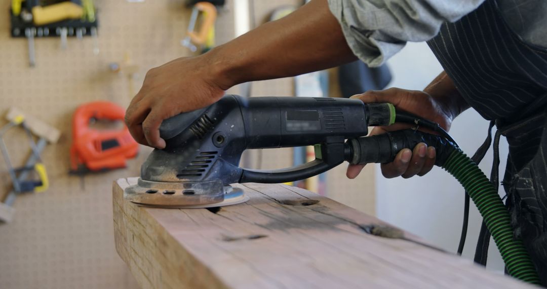 Woodworker Using Electric Sander On Wooden Plank In Workshop - Free Images, Stock Photos and Pictures on Pikwizard.com