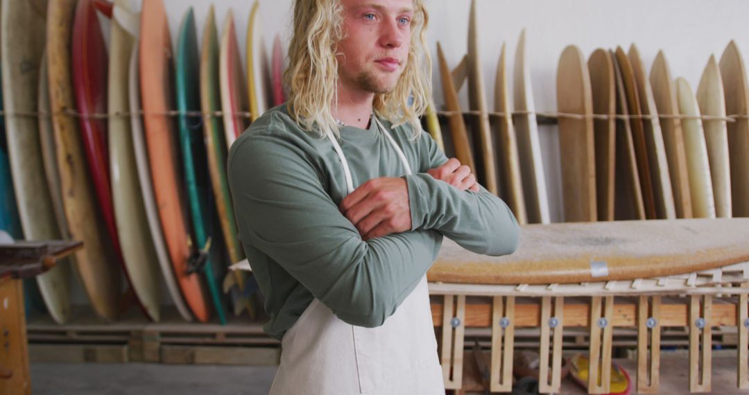 Thoughtful caucasian male surfboard maker with long blonde hair in apron at workshop, unaltered - Free Images, Stock Photos and Pictures on Pikwizard.com