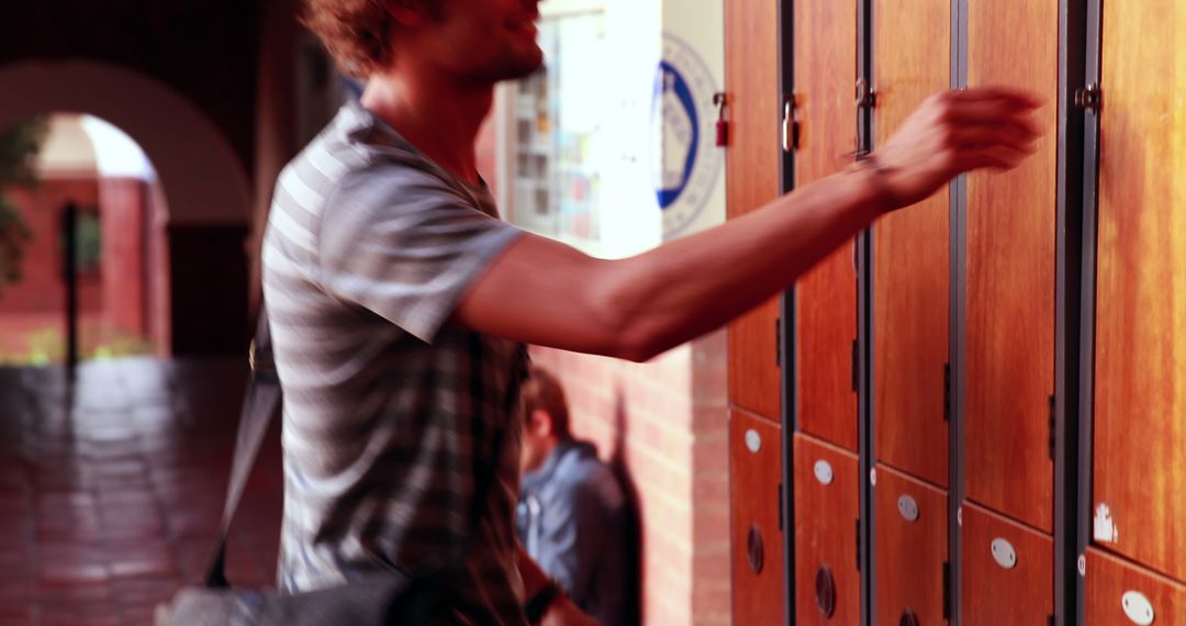University Student Accessing Locker in Hallway