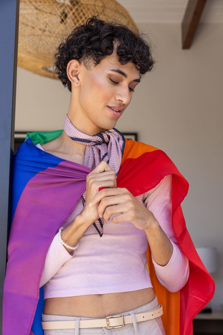 Young Person Embracing Identity with Rainbow Flag