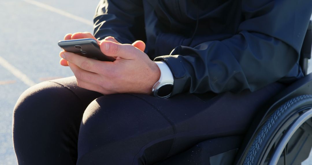 Person in Wheelchair Using Smartphone Outdoors - Free Images, Stock Photos and Pictures on Pikwizard.com