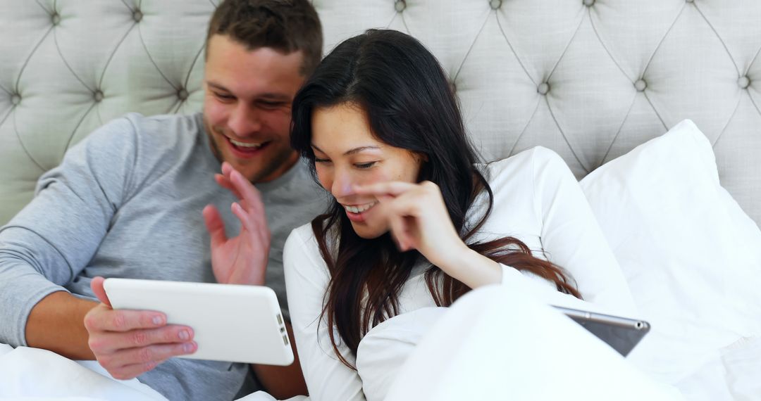 Happy Couple Enjoying Tablet Device in Bedroom - Free Images, Stock Photos and Pictures on Pikwizard.com