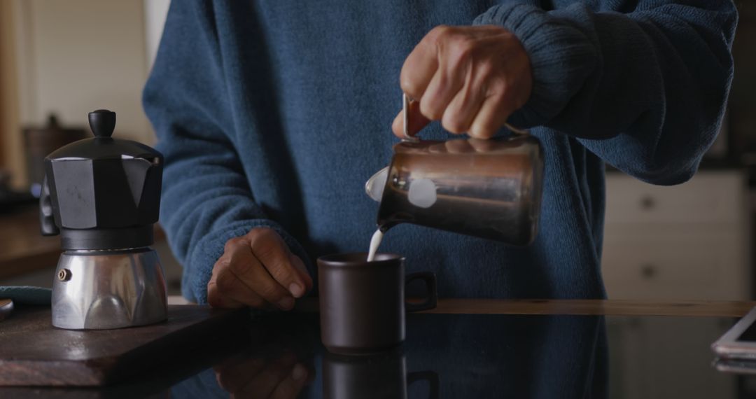 Person Pouring Milk Into Coffee Mug in Cozy Kitchen - Free Images, Stock Photos and Pictures on Pikwizard.com