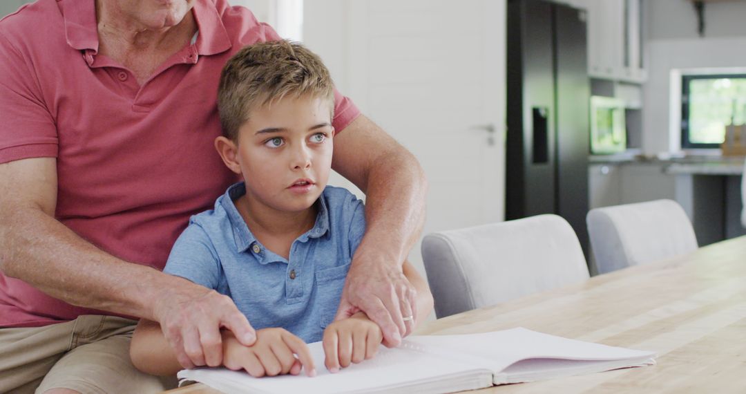 Grandfather Teaching Grandson to Read Braille at Home - Free Images, Stock Photos and Pictures on Pikwizard.com